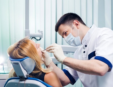 Dentist examining woman’s mouth