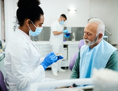 A dentist sharing tips on denture care with her patient