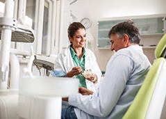 Dentist in Superior smiling while talking to patient about dentures