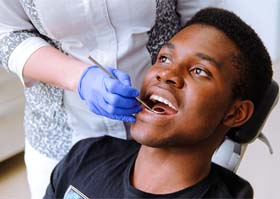 Man with dental implants in Superior visiting his dentist for checkup