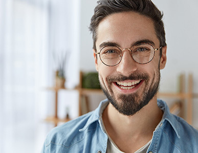 Young man with dental implants in Superior