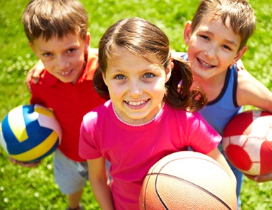 children smiling while playing in the park