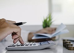 Woman calculating cost of root canal in Superior