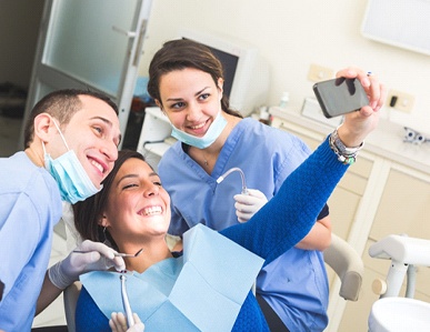 Woman taking selfie with dentist