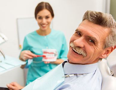 a patient smiling after teeth whitening in Superior