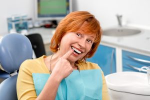 woman pointing to her tooth