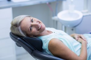 Smiling, comfortable woman in the dental chair. 