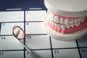 dental mirror laying on a calendar 