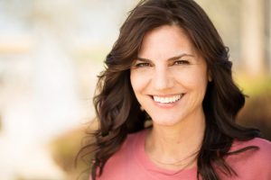 Woman smiling after visiting her dentist in Superior