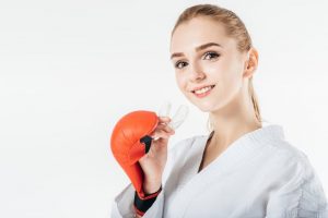Female holding mouthguard with boxing gloves
