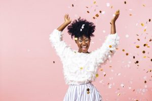 Woman throwing confetti for her New Year's resolution for more flossing