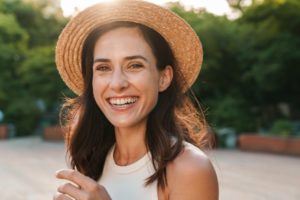 Woman smiling outside while avoiding ice cream