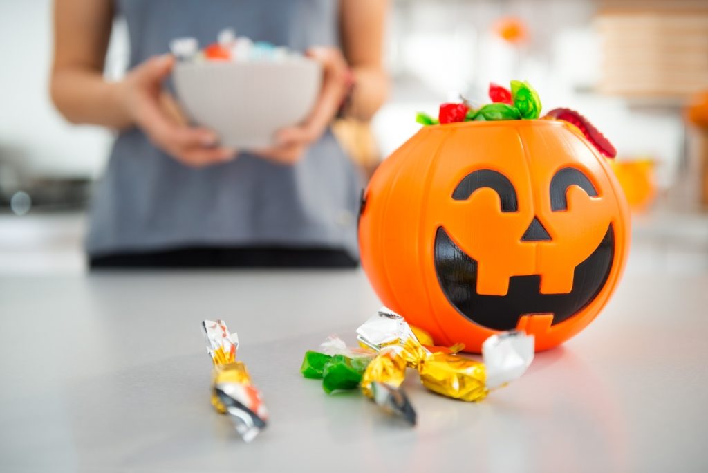 Closeup of plastic jack-o-lantern filled with Halloween candy
