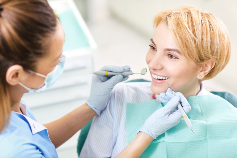 a female patient smiling at her dentist