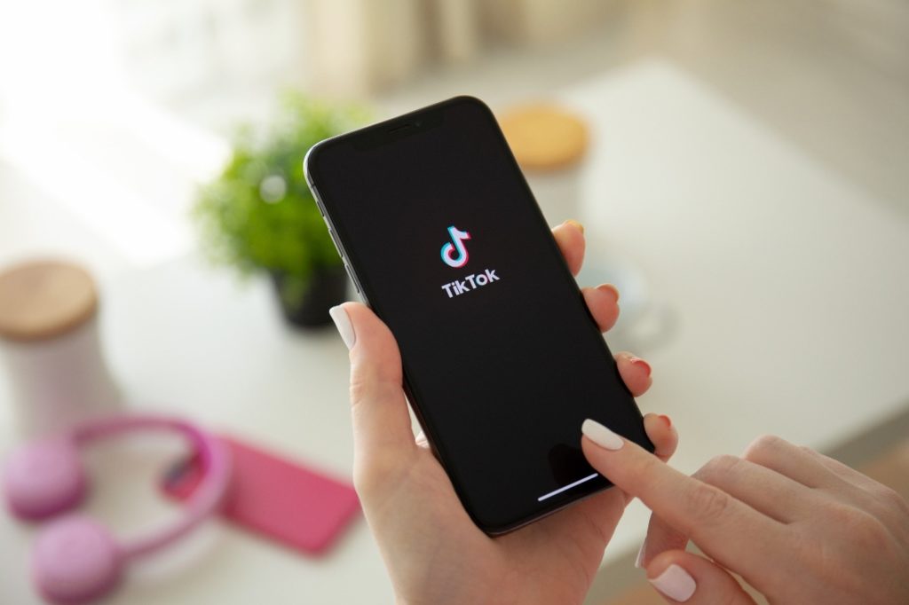 Woman opening TikTok app on phone