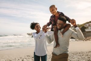 a family with beautiful smiles enjoying their summer vacation