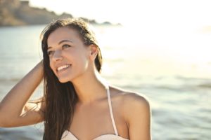 Young woman with beautiful teeth at beach
