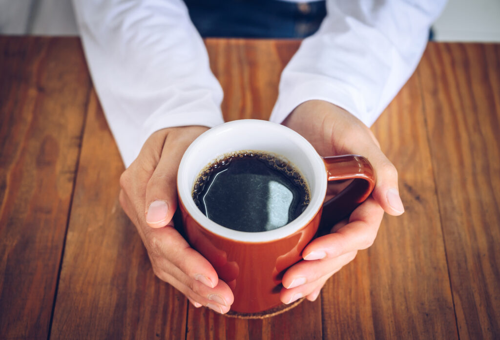 person holding cup of coffee