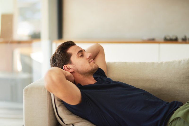 a man resting on his couch